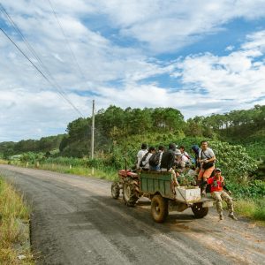 Group of people enjoying a tractor ride through the scenic countryside of Bảo Lộc, Vietnam.